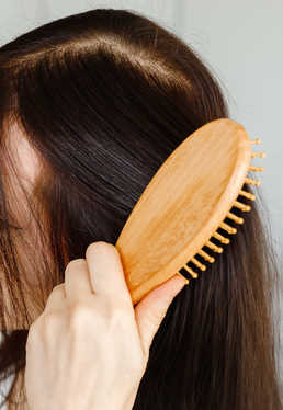 hair-care-closeup-of-woman-hairbrushing-hair-wit-2023-01-26-17-14-44-utc(1)